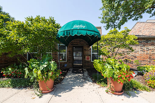 A welcoming clubhouse with a classic brick exterior and well-kept landscaping.