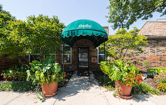 A welcoming clubhouse with a classic brick exterior and well-kept landscaping.