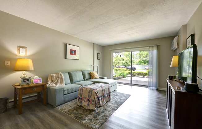 the living room has a large sliding glass door to the patio