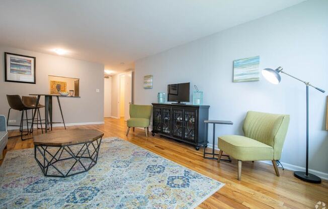 a living room with a couch and chairs and a table