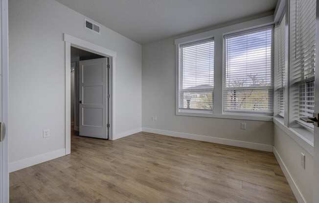 Empty bedroom space with windows