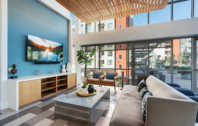 A modern living room with a flat screen TV on the wall.
