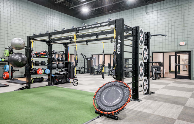 a tire in the center of a gym with weights and other equipment