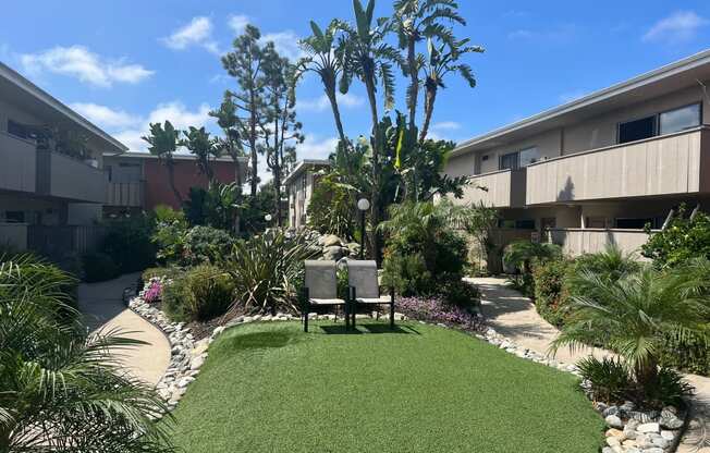 a small grassy area with a bench in front of a building