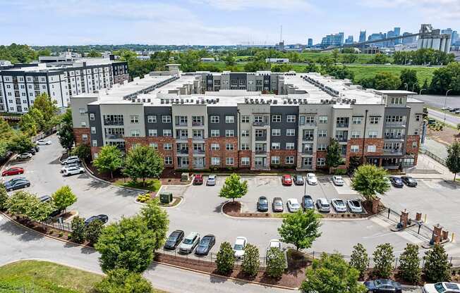 an aerial view of an apartment building in a parking lot