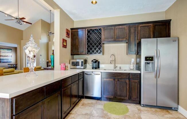 a kitchen with wooden cabinets and stainless steel appliances