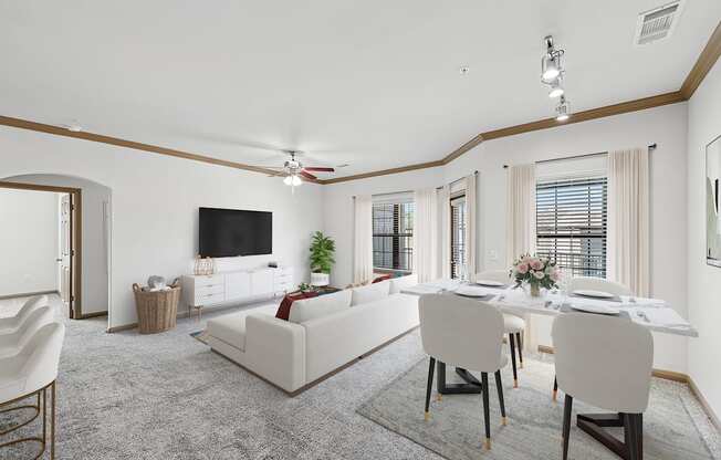 A living room with a white couch and a dining table set up.