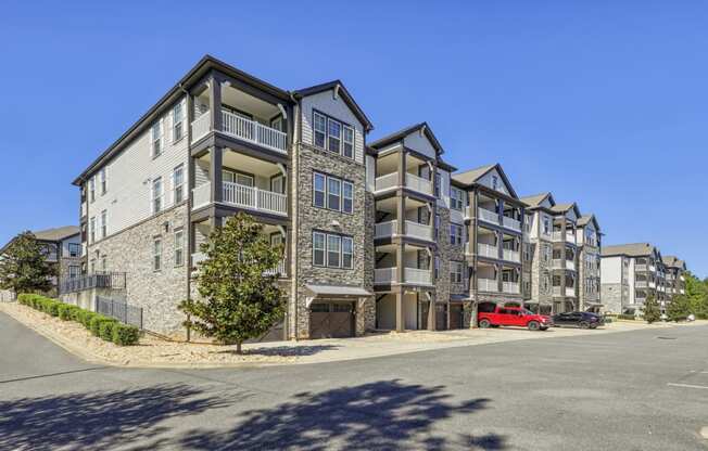 Side view of our apartments with balconies and built-in garage parking at Evergreen at Southwood in Tallahassee, FL