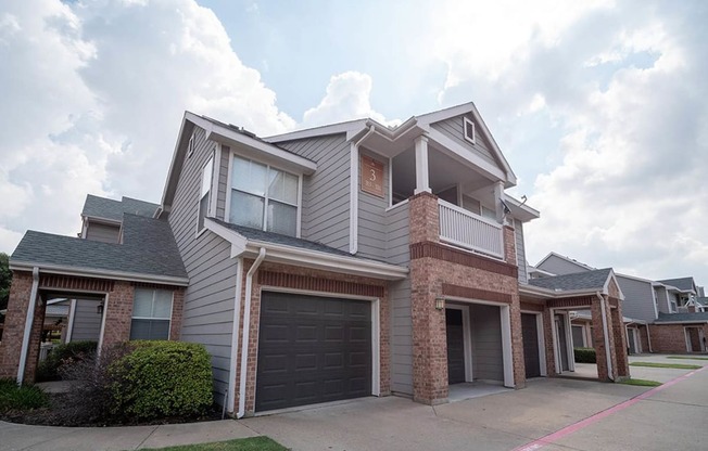 a house with a garage door in front of itat Creekside at Legacy, Plano, 75024