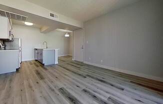 A room with a wooden floor and white walls.
