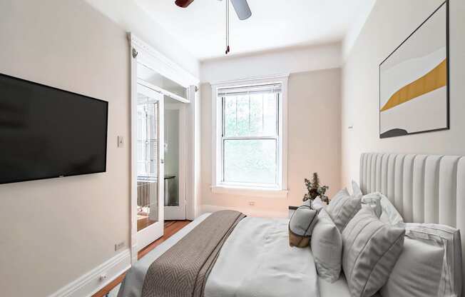 a bedroom with a large bed and a ceiling fan