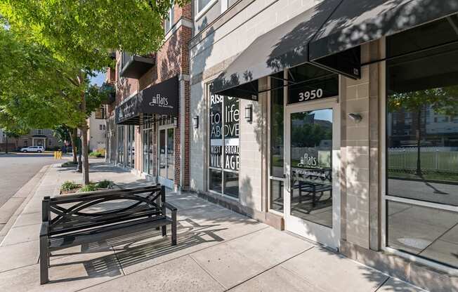 a bench on a sidewalk in front of a building