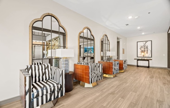 A room with striped chairs and wooden floors.