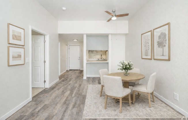 A dining room with a table and chairs.