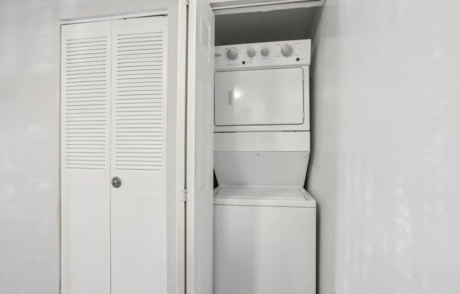 A white oven and microwave are installed in a kitchen.