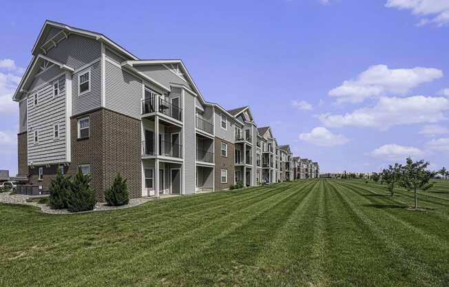 exterior of an apartment buildings with private patios and balconies at Trade Winds Apartment Homes in Elkhorn, NE 68022