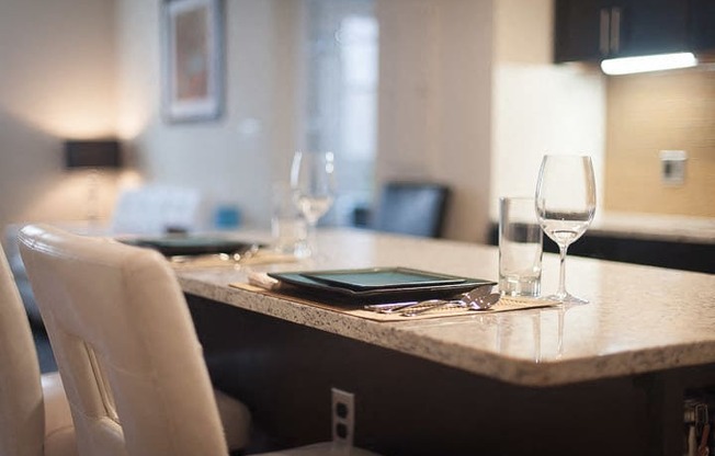 a table with a tablet and wine glasses on it
