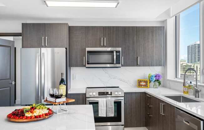 a kitchen with stainless steel appliances and a marble counter top