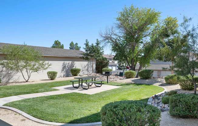 a picnic area with a picnic table in a yard