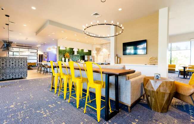 a dining room with yellow chairs and a table