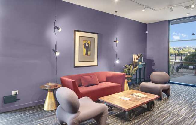 a living room with purple walls and a red couch