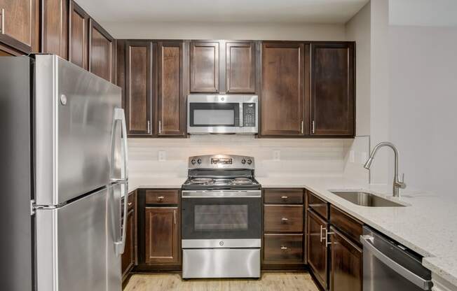 a kitchen with stainless steel appliances and wooden cabinets