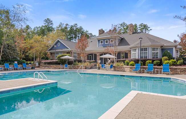 A large house with a pool in front.