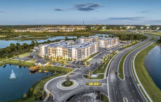 an aerial view of a large building next to a highway and a body of water at The Overlook, Winter Garden, FL