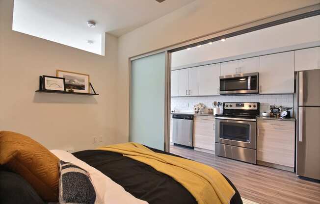 The Merc Apartments Model Bedroom and Kitchen Wall