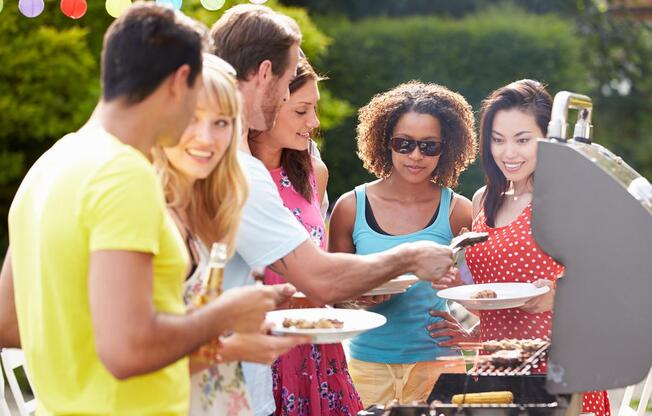 a group of people looking at a birthday cake