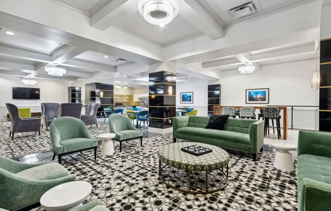 a lobby with green couches and chairs and a black and white checkered floor