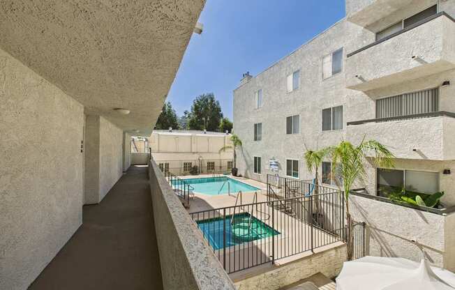 A long hallway with a pool on the other side.