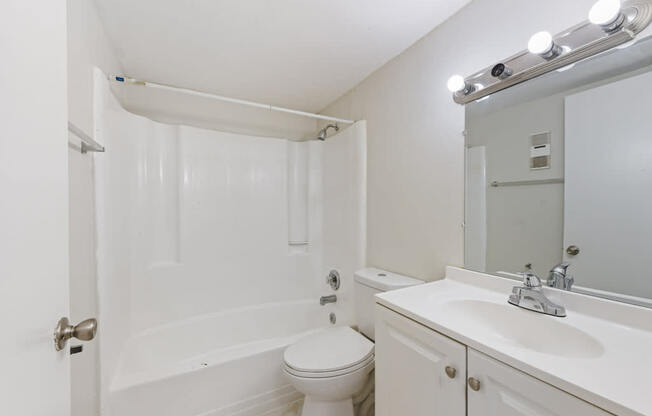 a bathroom with a sink toilet and a mirror