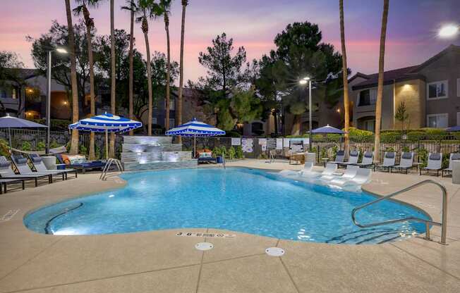 The shimmering water reflects the colors of the sunset, creating a serene atmosphere perfect for unwinding after a long day at our updated pool.