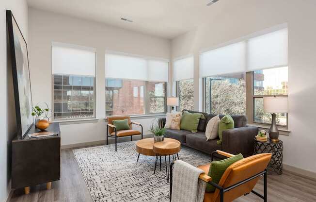 A living room with a brown couch, a coffee table, and a television.