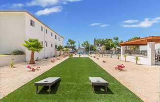 a garden outside a building with grass and benches at Sunnymead Apts Apartments, Moreno Valley, CA