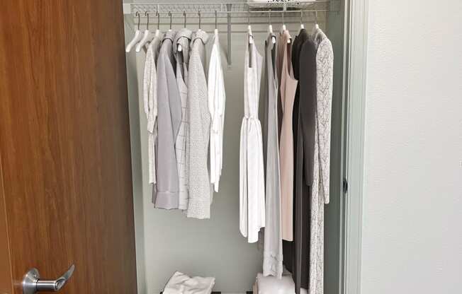 a walk in closet with a wooden door and two wooden boxes on the floor