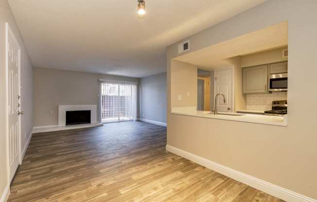 an empty living room and kitchen Of Vine apartment in Arlington, TX