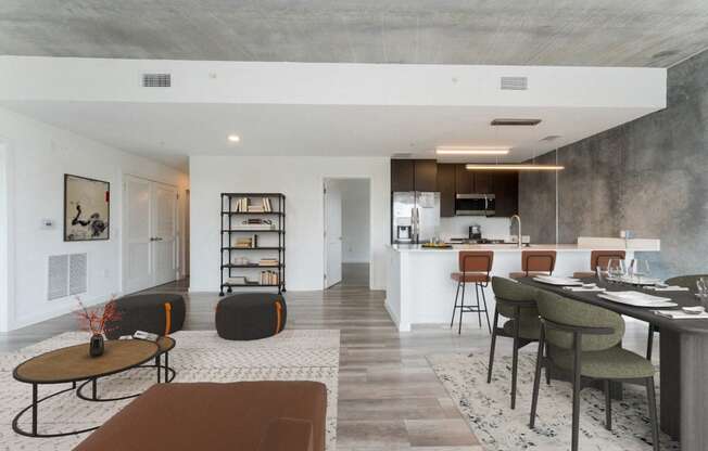 a living room and kitchen with a table and chairs