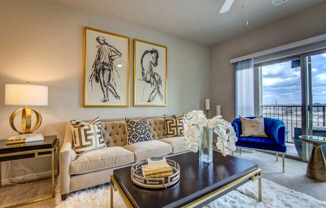 a living room with a couch and a table with a vase of flowers on it