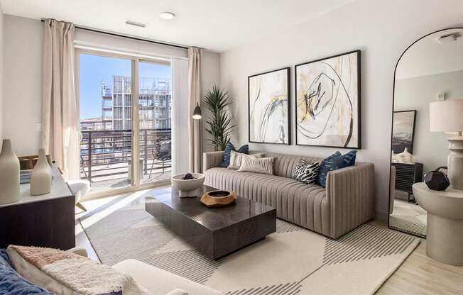 a living room with a couch and a table   and a balcony