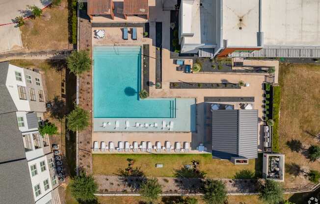 An aerial view of a swimming pool surrounded by buildings.
