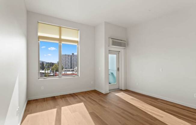 A room with a window overlooking a cityscape.