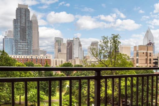 the view of the city skyline from the balcony of a condo