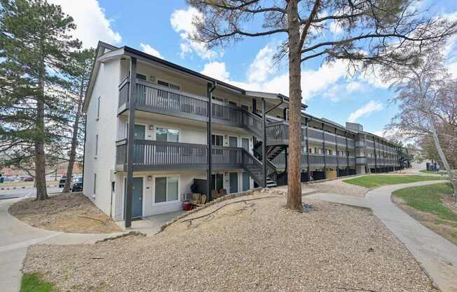 Apartment building with a tree in front of it.