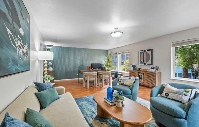 A living room with a couch, chairs, and a coffee table.