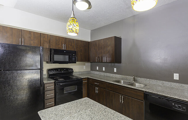 interior photo of a kitchen with brown cupboards from The Lotus Apartments in Downtown Salt Lake City, Utah