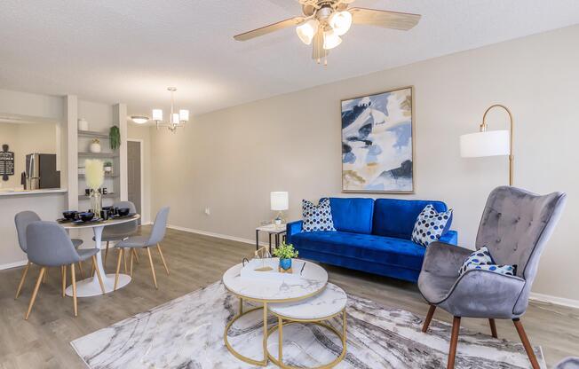 a living room filled with furniture and a blue chair