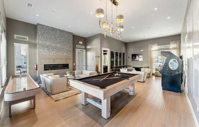 A large room with a pool table and a billiard table.