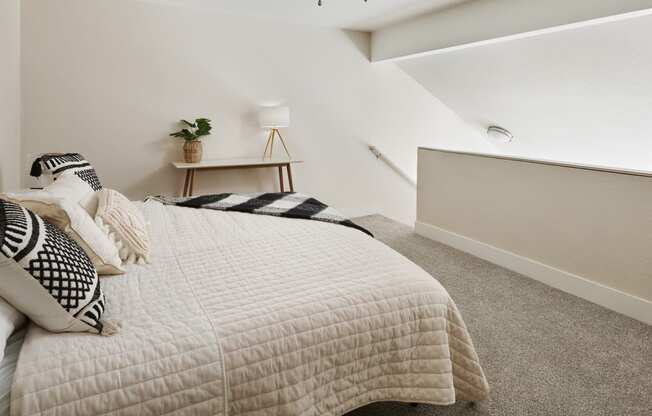 a bedroom with a bed and a nightstand